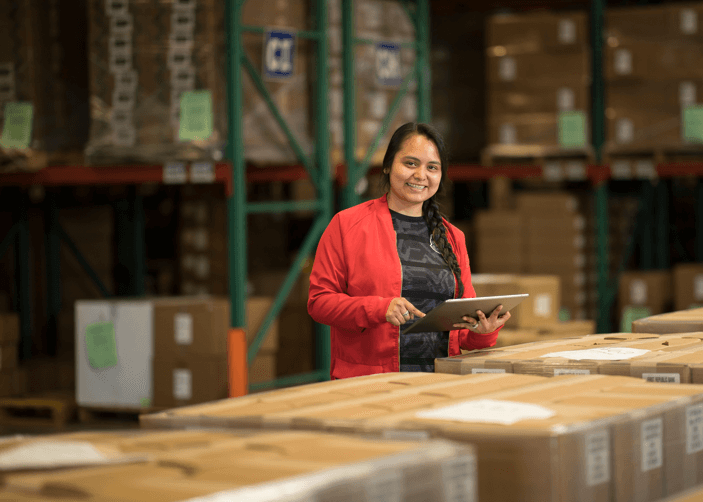 Smiling ALOM employee in a warehouse