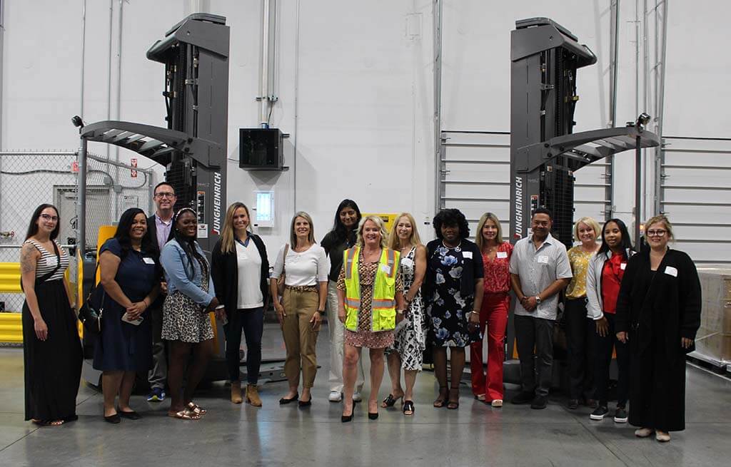 Tour attendees in front of equipment